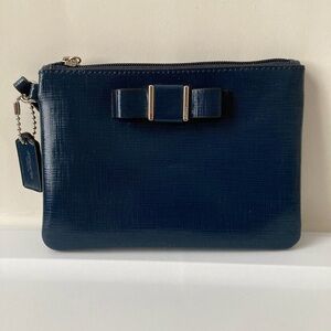 Navy Coach wristlet with bow.